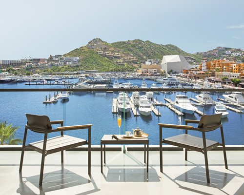 View of patio tables facing a marina on the waterfront.