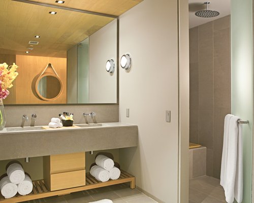 A bathroom with a standup shower and double sink vanity.