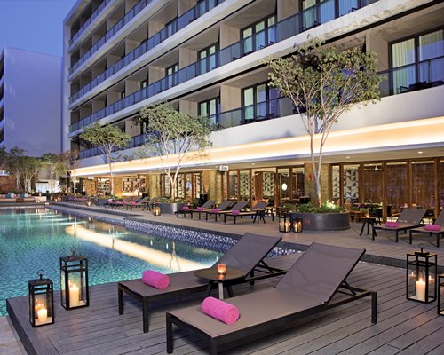 An outdoor swimming pool with chaise lounge chairs.