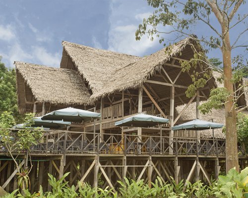 Scenic exterior view of the resort unit with a thatched roof.