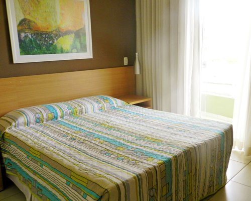 A well furnished bedroom with an outside view.