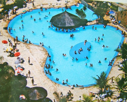 People enjoying in an outdoor swimming pool.