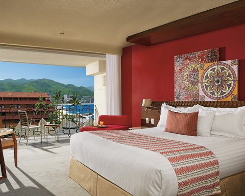 A well furnished bedroom with two beds and an outside view.
