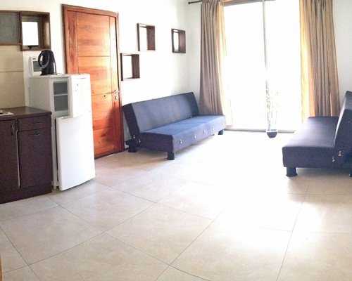 A well furnished living room with a refrigerator.