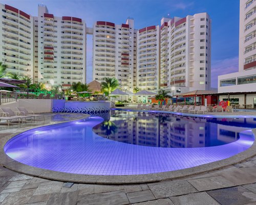 View of two hot tubs with garden furniture and landscaping alongside the resort.