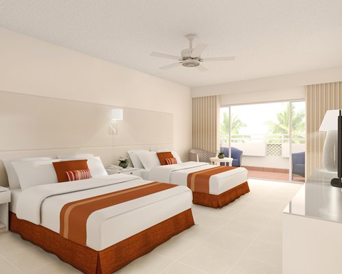 room with double beds and balcony at Melia Caribe Tropical GG
