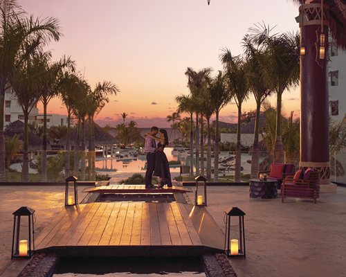 A couple in an outdoor area alongside trees in the resort property.