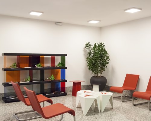 A well furnished indoor lounge area with a potted plant.