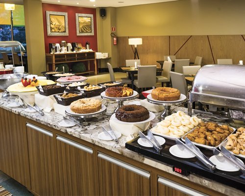 An indoor buffet area with various foods.