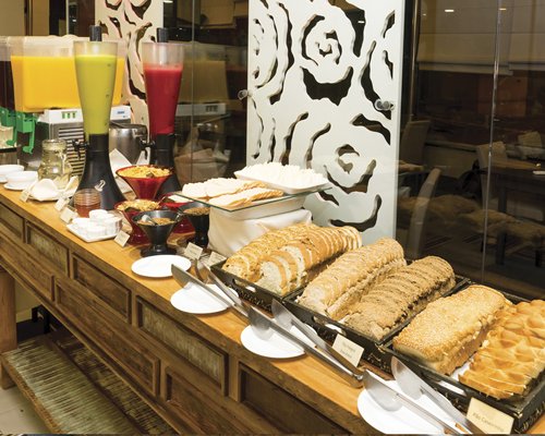 View of food items and beverages on a buffet table.