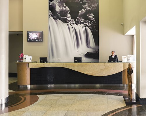 A well furnished reception at the resort with a television.