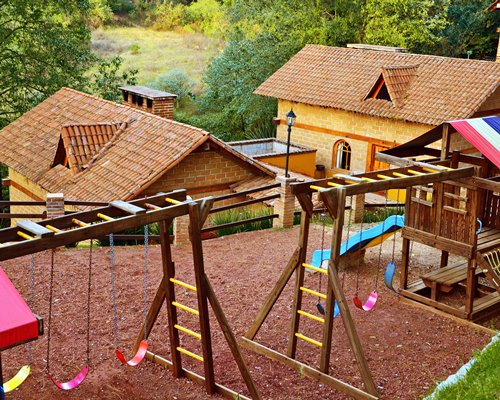 An outdoor playscape area alongside the resort units.