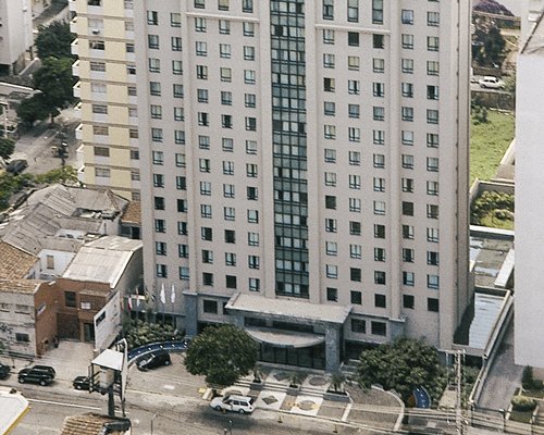 An exterior view of the multi story condo with a parking lot.