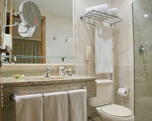 A bathroom with a standing shower stall and single sink.