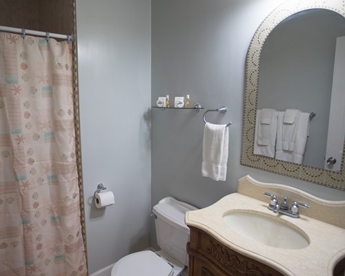 A bathroom with a shower stall and single sink vanity.
