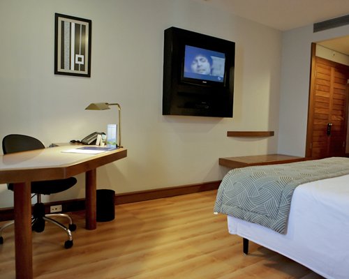 A well furnished bedroom with a television.