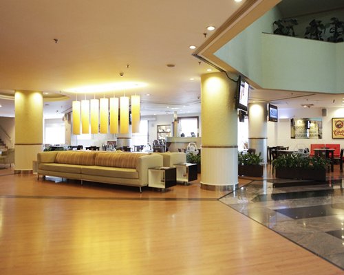 A view of the reception area with lounge access and two television.