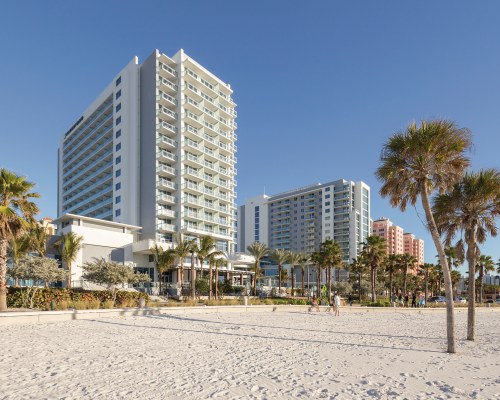 AN EXTERIOR VIEW OF MULTI STORY RESORT UNITS WITH TREES.