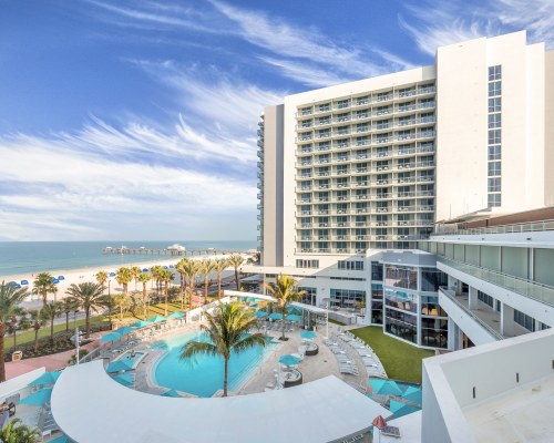 WYNDHAM CLEARWATER BEACH RESORT WITH AN OUTDOOR SWIMMING POOL ALONGSIDE THE OCEAN.