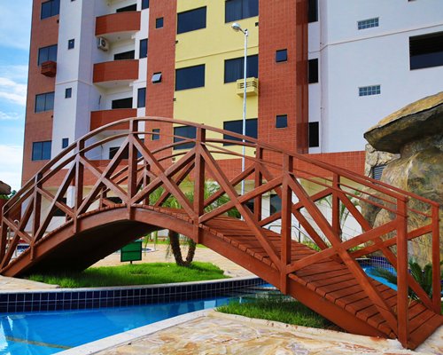A bridge over the swimming pool alongside the resort.