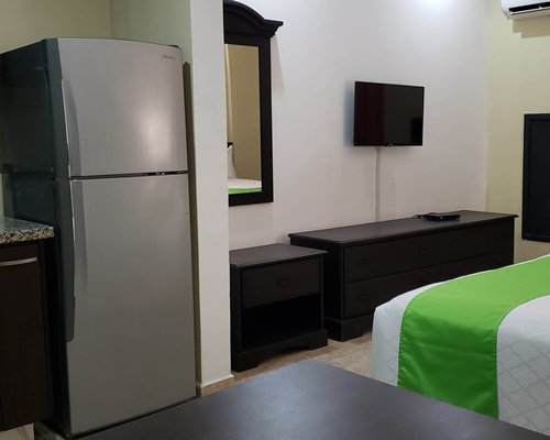 A well furnished living room with double pull out sofa and an open plan kitchen.