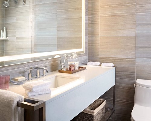 A bathroom with a shower stall and single sink vanity.