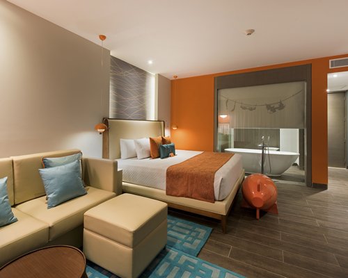 comfortable, contemporary room with soaker tub, lounge area and large bed - Nickelodeon Resort Punta Cana