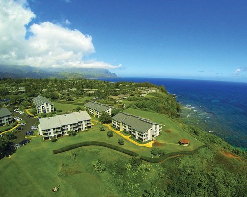 Scenic aerial view of resort overlooking landscaped grounds and ocean.