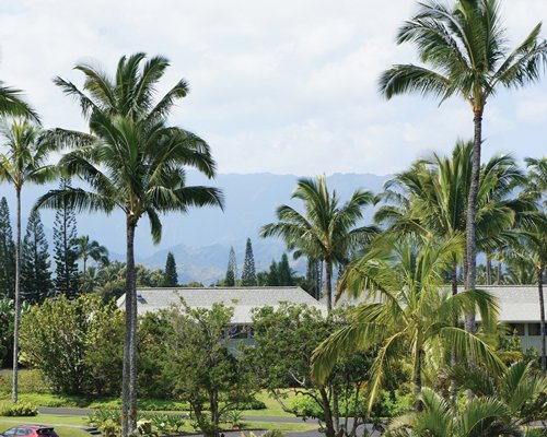 View of resort landscaped with trees and mountain views.