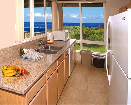 A kitchen area with windows showing ocean views.