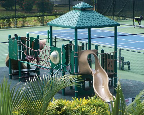 A view of outdoor kids play gym and tennis courts.