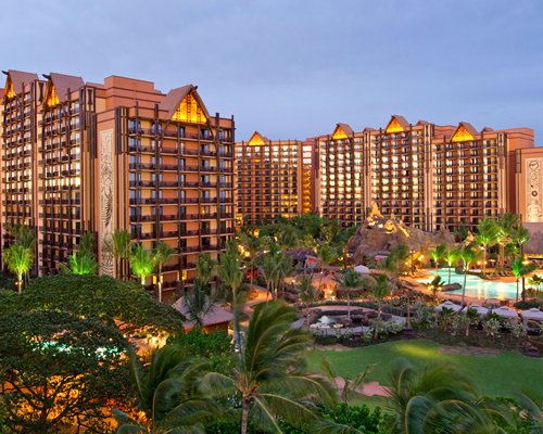 An exterior view of the Aulani Disney Vacation Club Villas at dusk.