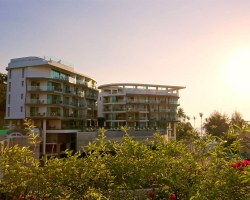 Modern seaside apartment complex at sunset