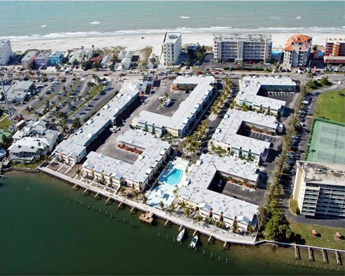 An aerial view of the resort property alongside the beach and the waterfront.