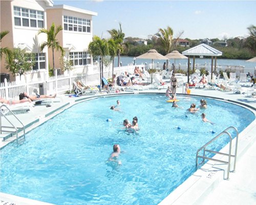 People enjoying Barefoot Beach Resort's swimming pool.