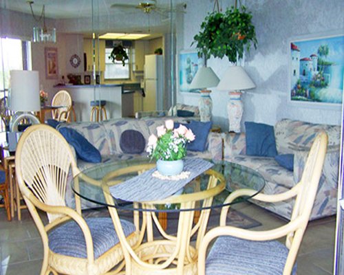 Living room with dining area open plan kitchen breakfast bar and outside view.