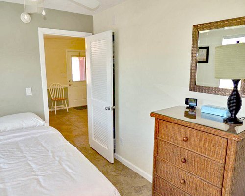 A well furnished bedroom with a mirror.