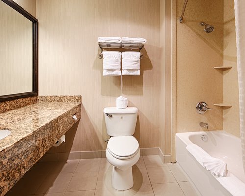 A bathroom with sink vanity and bathtub shower.