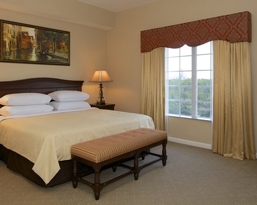 King size bed with the view of the city at WorldQuest Orlando Resort