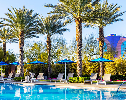 Scene of a poolside with a hotel in the distance