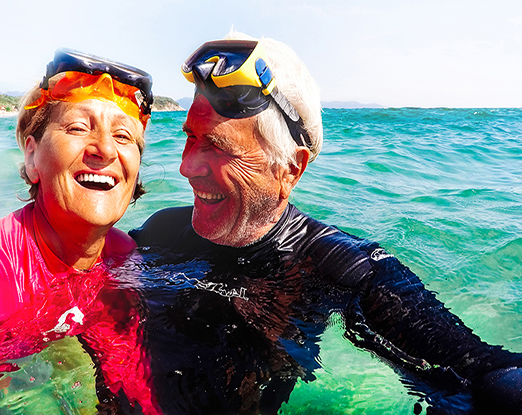 An older couple floating in the ocean