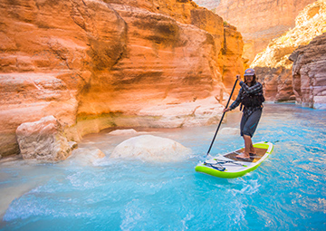 A person paddleboating on a waterway in an Arizonian canyon