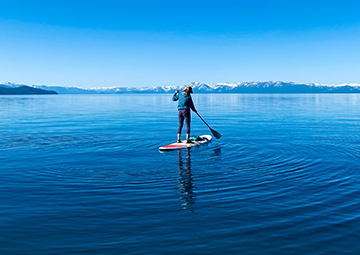 A person paddling on a large body of water