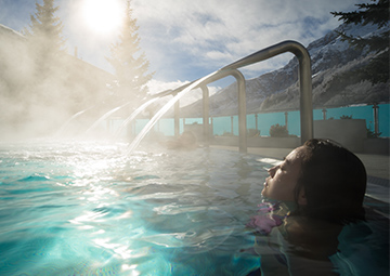 A woman soaking in a heated pool