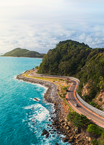 An aerial view of a winding oceanside road