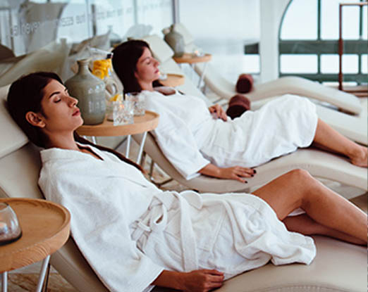 Two women relaxing in spa lounge chairs