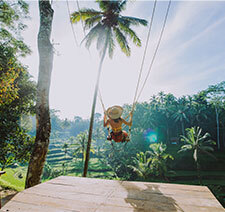 A woman swinging in a swing at a resort