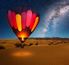 A colorful hot air balloon before flight on a starry evening