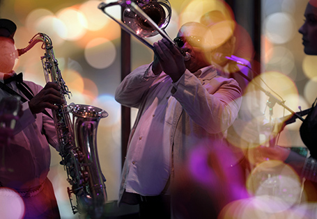 A band playing saxophones and trombones on stage