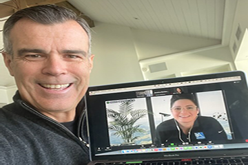 Olivier Chavy holding laptop on a virtual meeting with Alecea Helton